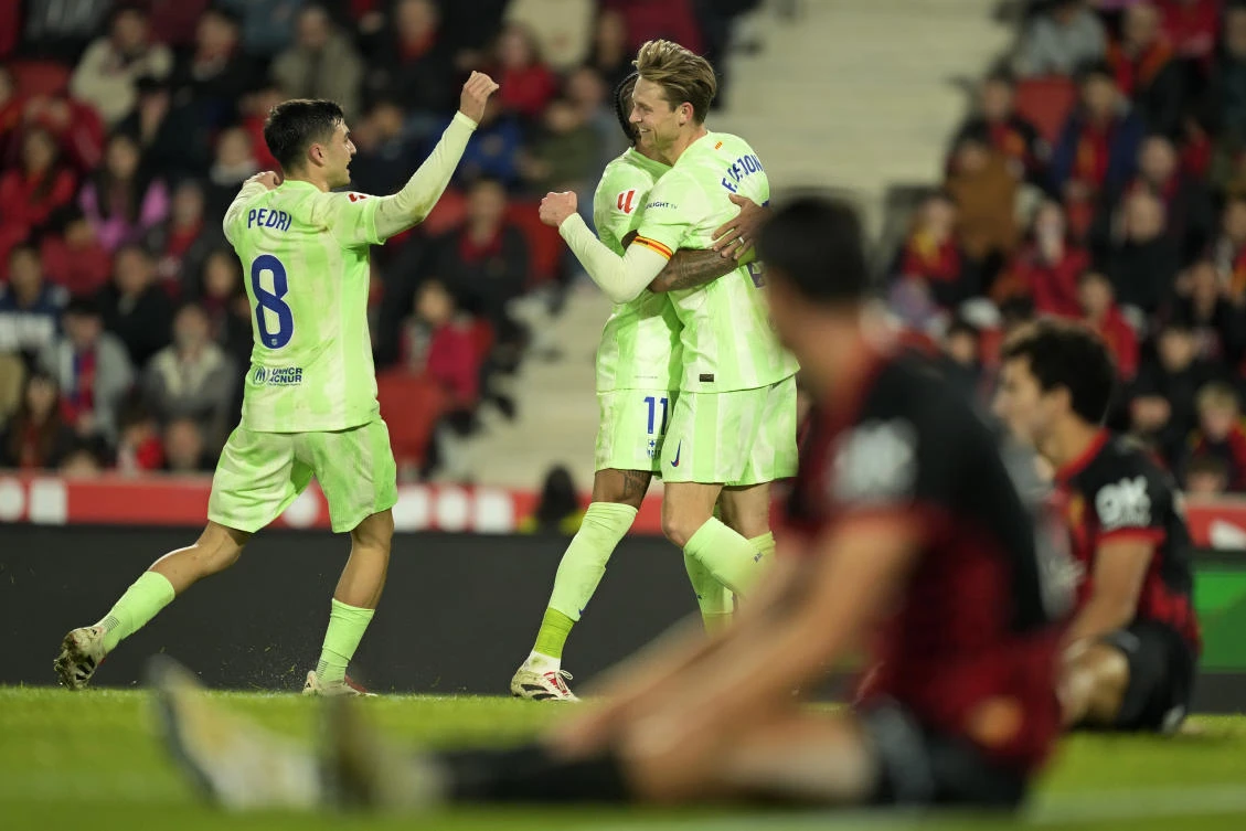 Barcelona’s Frenkie de Jong celebrates with Raphinha and Pedri after scoring his side’s fourth goal during their La Liga match against Mallorca at the Son Moix stadium in Palma de Mallorca, Dec. 3, 2024. (AP)