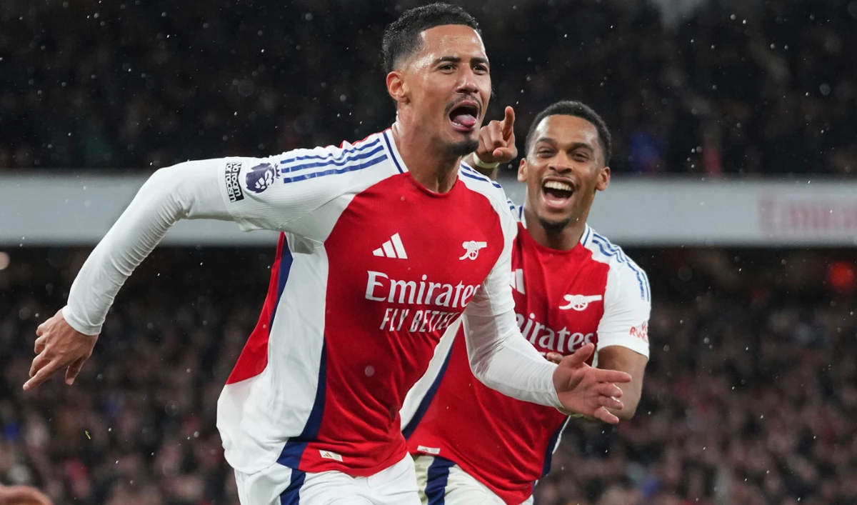 Arsenal's William Saliba, left, celebrates after scoring his side's second goal during the English Premier League soccer match between Arsenal and Manchester United at Emirates stadium in London, Wednesday, Dec. 4, 2024. (AP)