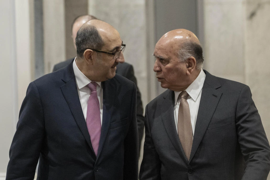 Syrian Foreign Minister Bassam Sabbagh, left, arrives to meet his Iraqi counterpart Fouad Hussein during his visit to Baghdad on Friday. (AP)