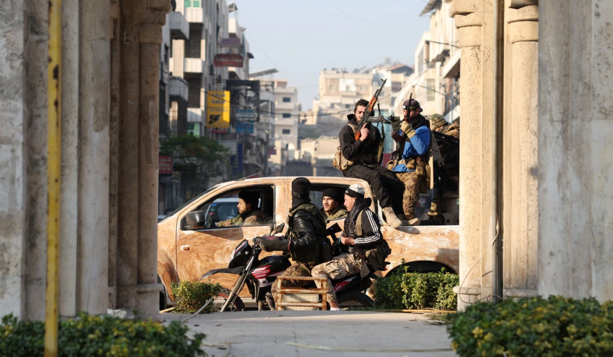 Anti-government fighters patrol the streets of Hama after they captured the central Syrian city, on December 6, 2024. (AFP)