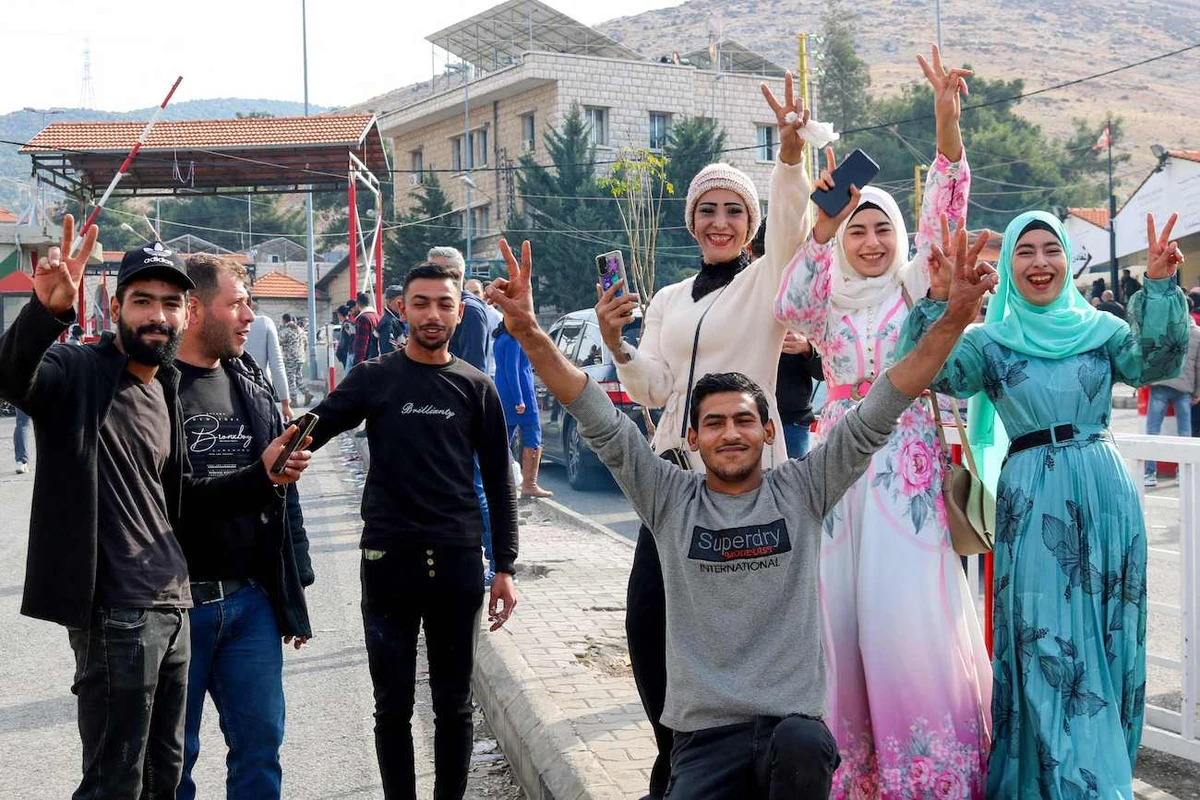 Syrians celebrate as they return to Damascus via Lebanon’s Masnaa border crossing east of Beirut on December 8, 2024, following the fall of the Syrian capital to anti-government fighters. (AFP)