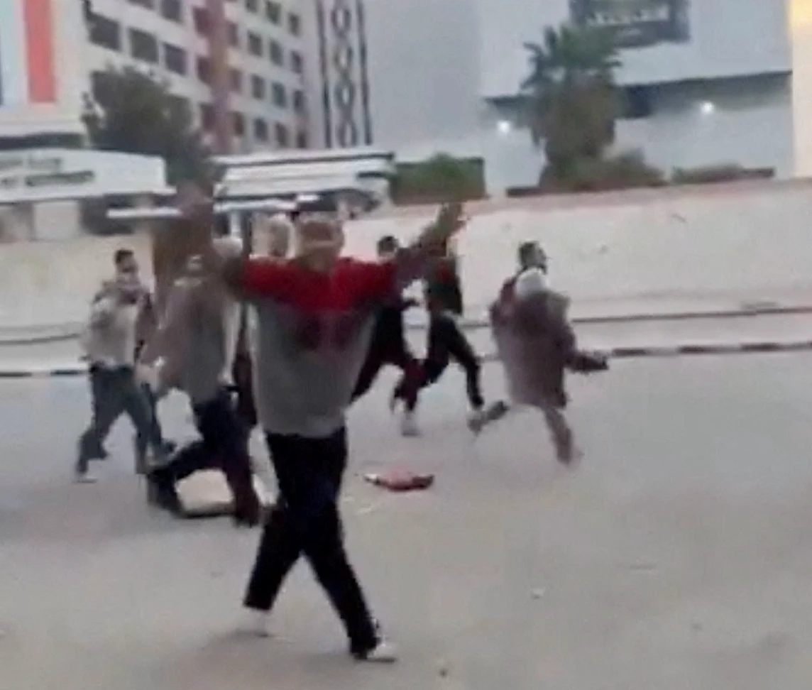A person gestures as individuals, reportedly freed prisoners, run in the streets of Damascus, Syria, December 8, 2024, in this picture obtained from social media video. (Reuters)