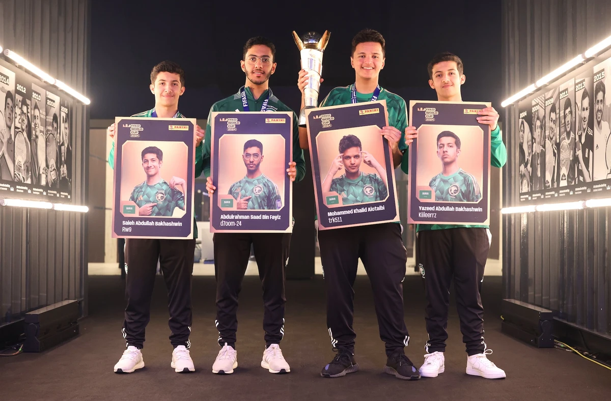 Players of Team Saudi Arabia pose for a photo with their panini cards after winning the FIFAe World Cup featuring Rocket League at SEF Arena in Riyadh, Saudi Arabia (Gonzalo Arroyo/FIFA)