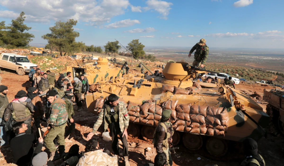 This Jan. 28, 2018 file photo, Turkish troops and pro-Turkey Syrian fighters try to take control of Bursayah hill, which separates the Kurdish-held enclave of Afrin from the Turkey-controlled town of Azaz, Syria. (AP)
