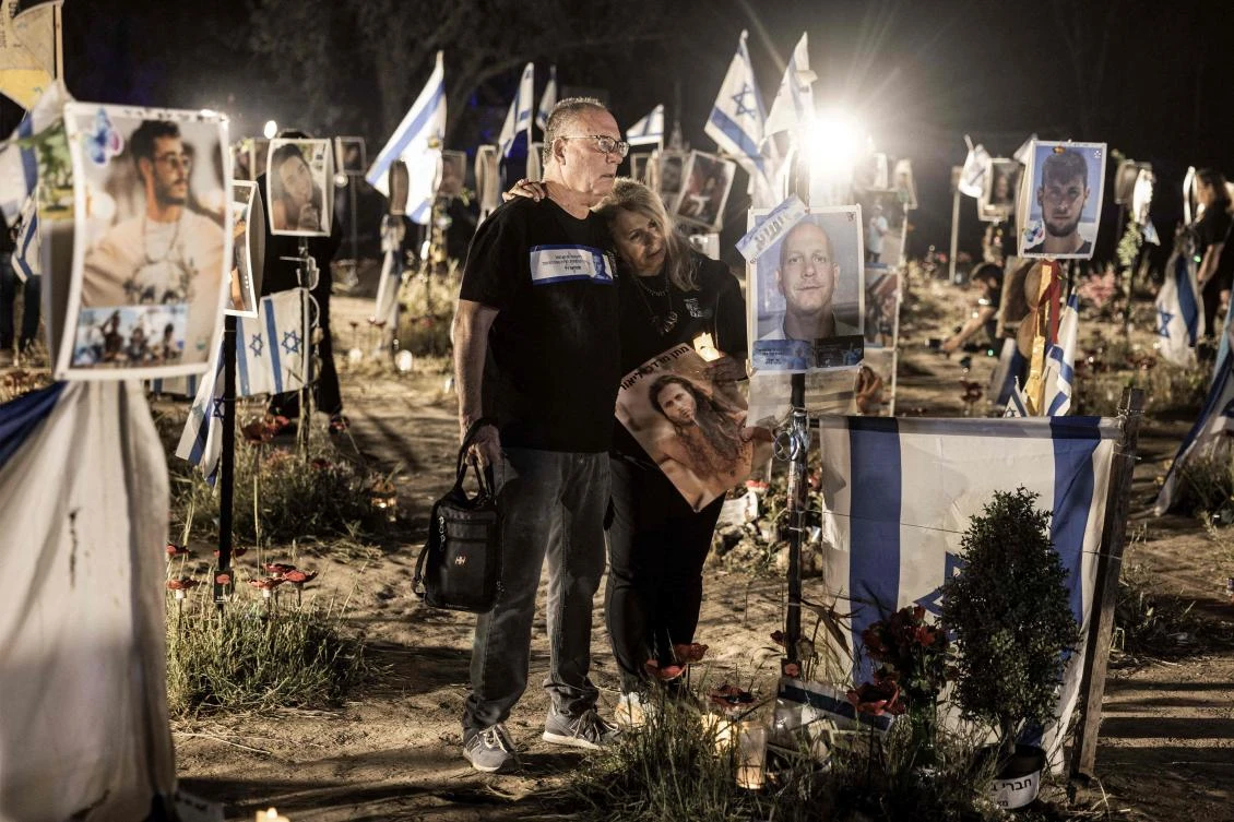 Relatives of victims of the Oct. 7 attacks visit an installation bearing the photos of their loved ones who were killed or kidnapped during the attacks, at the site of the Nova festival, in Re’im, southern Israel on Apr. 2, 2024. (AFP/File)