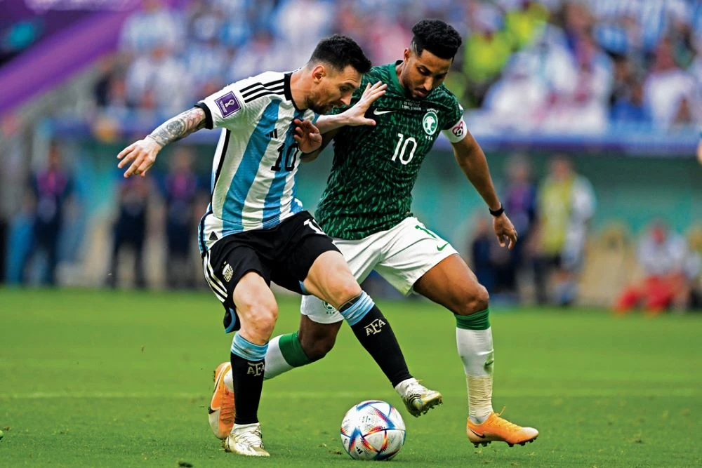Saudi Arabia’s Salem Al-Dawsari goes up against Argentina’s Lionel Messi during a World Cup match in which the Saudi side scored a historical upset at Qatar’s Lusail Stadium on Nov. 22, 2022. (AFP)