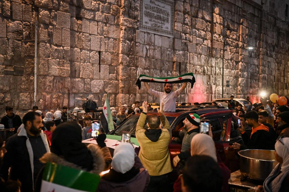 People celebrate outside the Ummayad mosque in the old city of Damascus on Dec. 11, 2024. (AFP)