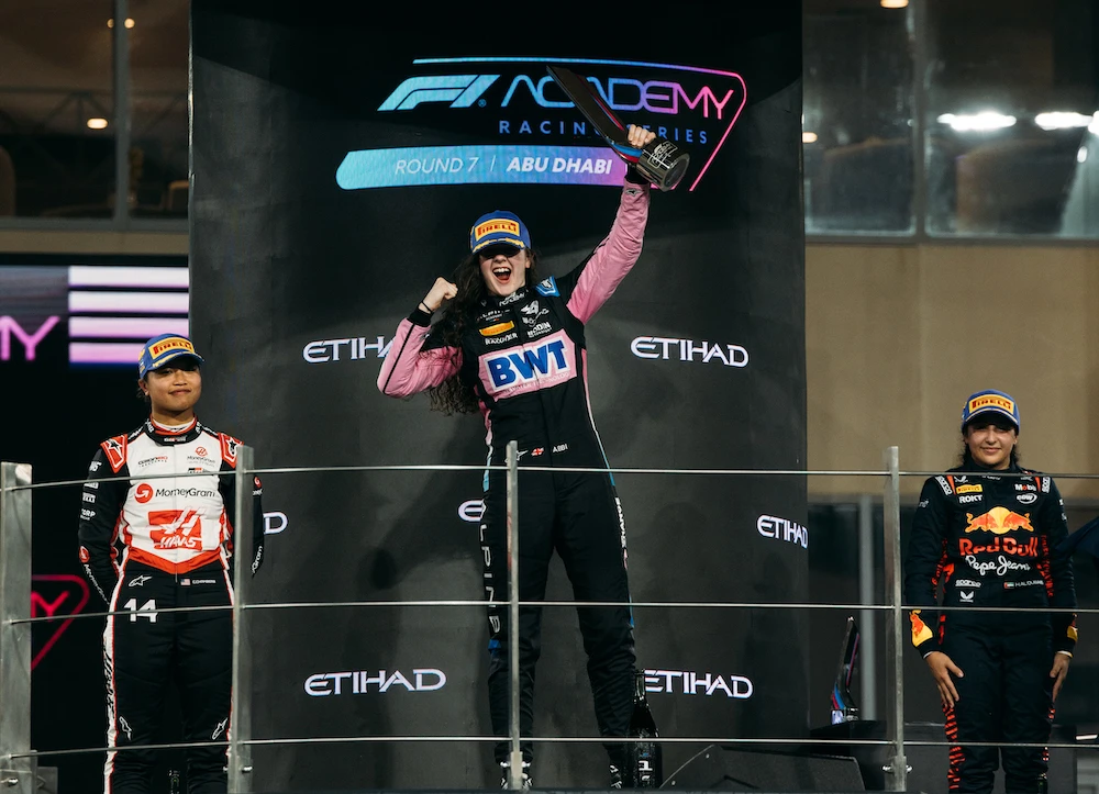 Abbi Pulling, center, celebrates on the podium after Race 2 of the F1 Academy championship at Abu Dhabi’s Yas Marina Circuit. (X: @f1academy)