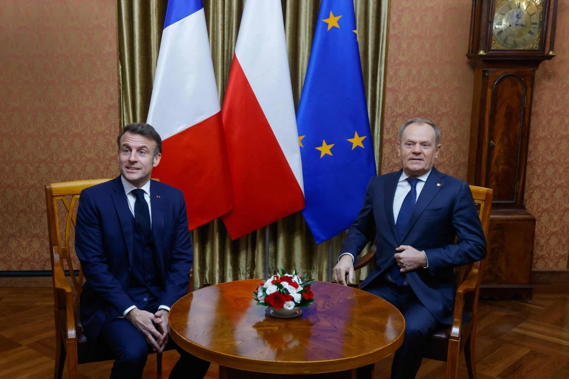 Poland’s Prime Minister Donald Tusk and French President Emmanuel Macron are seated prior to a meeting at the PM’s office in the Polish capital Warsaw, on Dec. 12, 2024. (AFP)