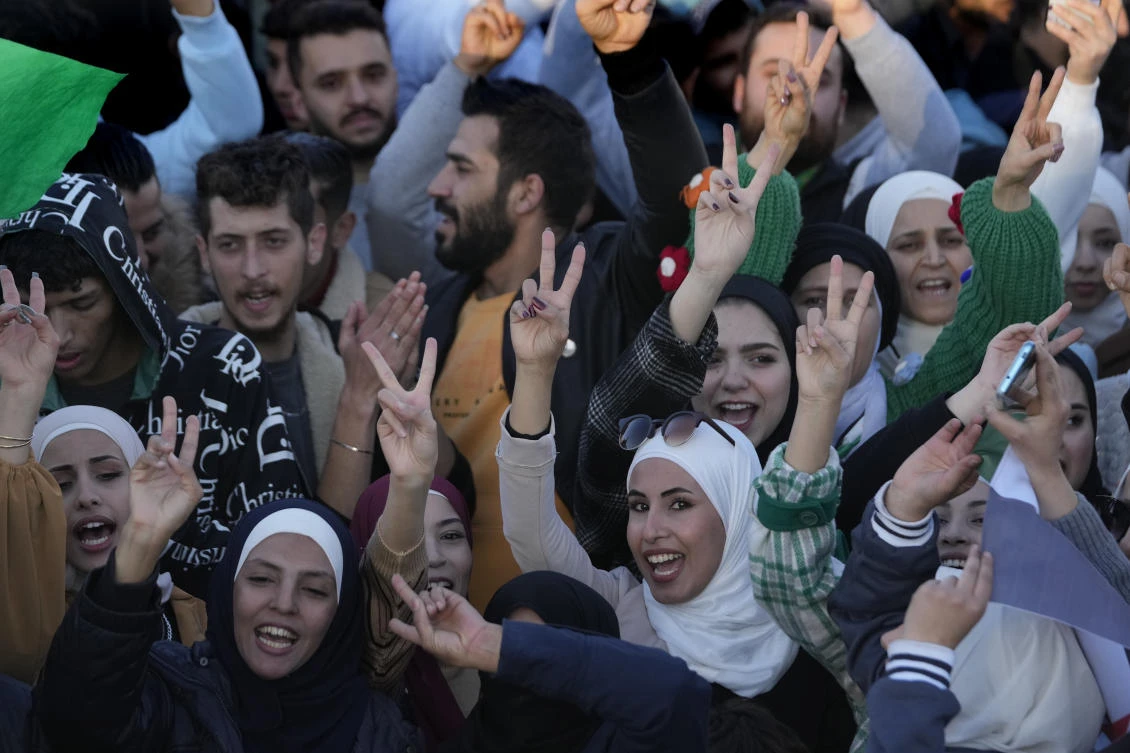 Syrians celebrate during a demonstration following the first Friday prayers since Bashar Assad's ouster, in Damascus' central square on Friday. (AP)