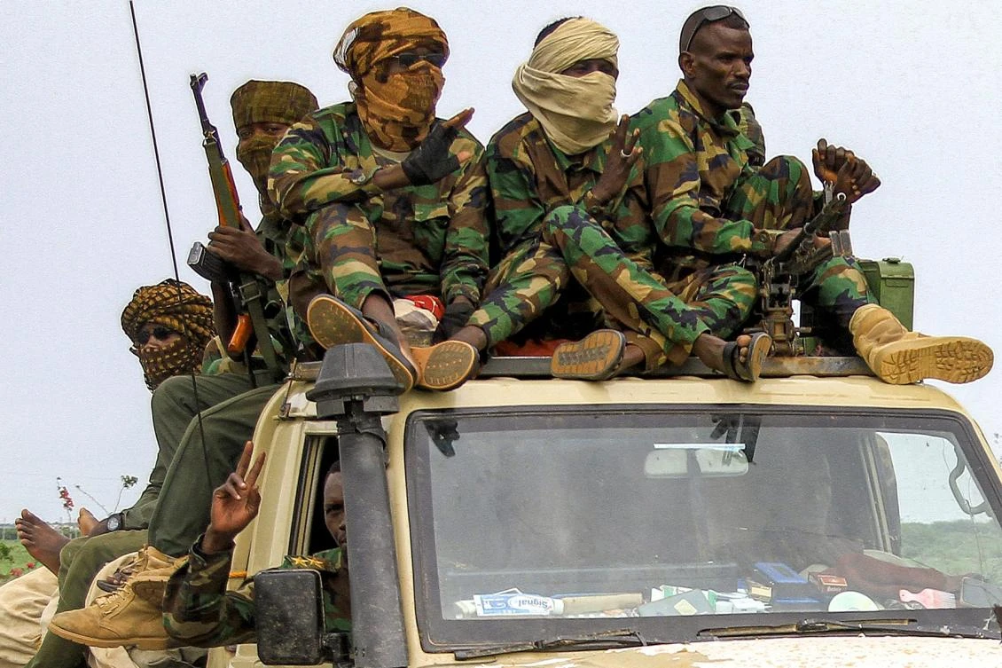 Fighters ride in a vehicle moving in a military convoy accompanying the governor of Sudan's Darfur State during a stopover in the eastern city of Gedaref while on the way to Port Sudan on August 30, 2023. (Photo by AFP)