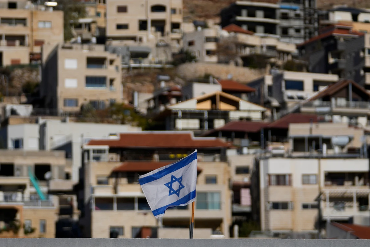 An Israeli flag flies on a roof in the town of Majdal Shams, near the so-called Alpha Line that separates the Israeli-controlled Golan Heights from Syria, Sunday, Dec. 15, 2024. (AP)