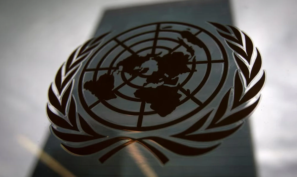 The United Nations headquarters building is pictured through a window with the UN logo in the foreground in the Manhattan borough of New York August 15, 2014. (Reuters)