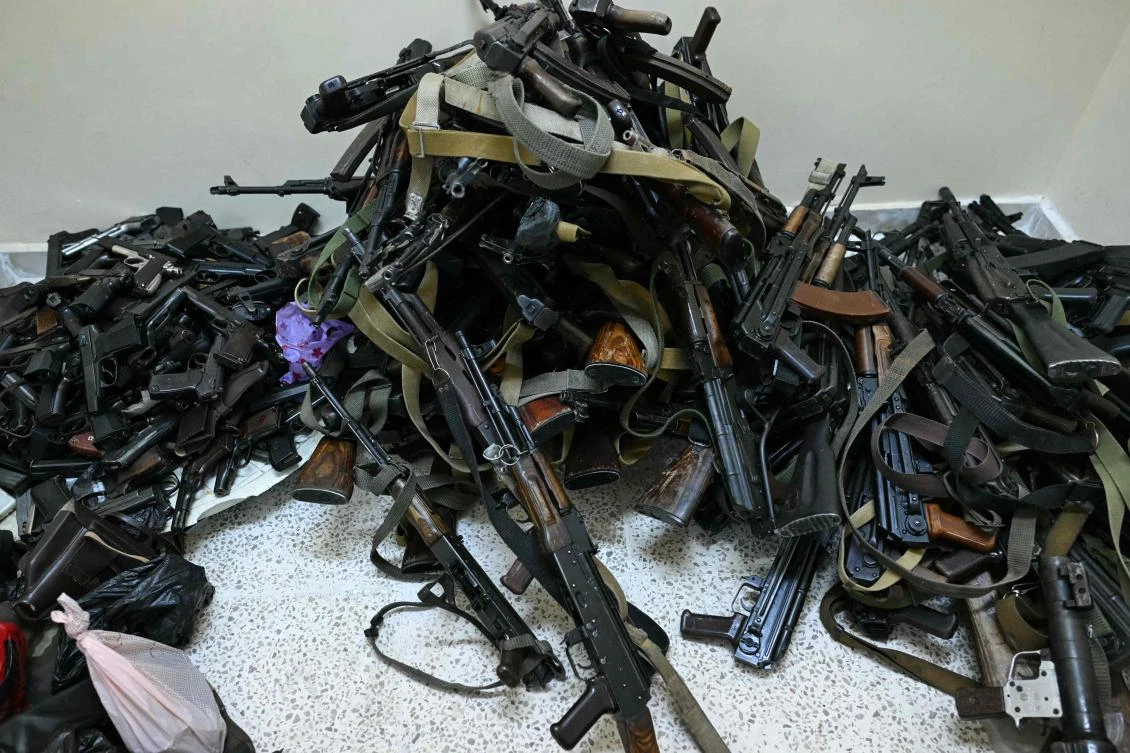 Firearms handed over to Syria's new authorities, pile up as Syrian soldiers, police and a some civilians surrender their weapons and register with the authorities, in the western port city of Latakia, on December 16, 2024. (AFP)