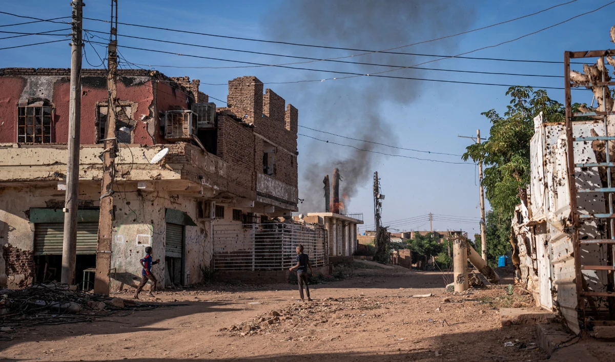 Boys check a fire that broke out in a destroyed house in a war-torn neighborhood in Omdurman on November 2, 2024. (AFP/File)
