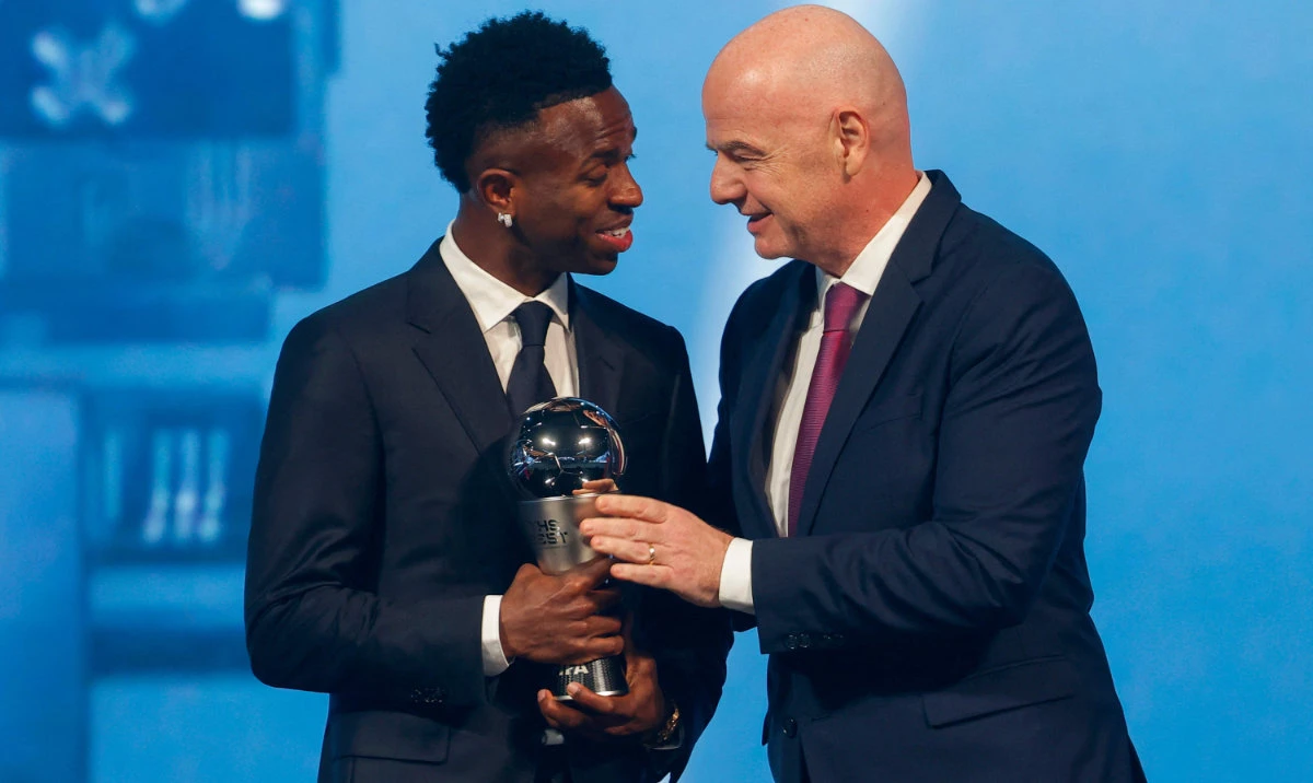 Brazilian forward Vinicius Junior (L) receives the Best Player trophy from FIFA President Gianni Infantino during the Best FIFA Football Awards 2024 ceremony in Doha on Dec. 17, 2024. (AFP)