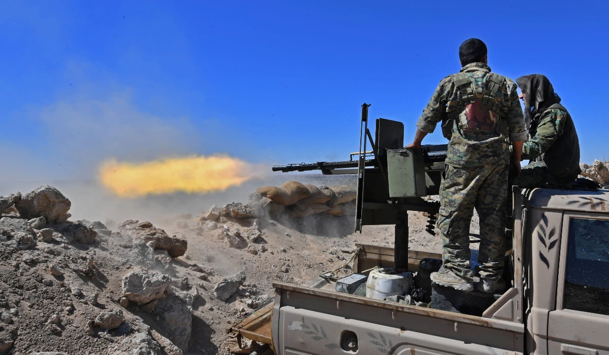 A fighter with the Syrian Democratic Forces (SDF) fires a truck-mounted gun toward a part of Baghouz where remaining Islamic State (IS) group fighters are holding out in their last position, in the countryside of the eastern Syrian province of Deir Ezzor on March 18, 2019. (AFP)