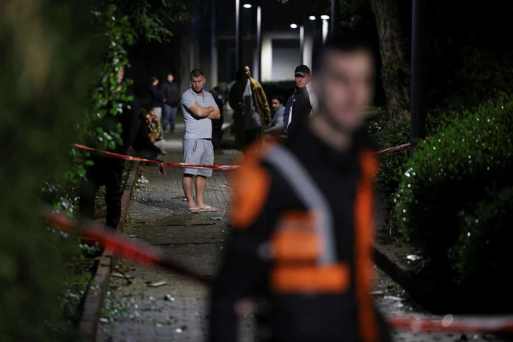 Residents gather at the scene of a missile strike that, according to Israel’s military, was launched from Yemen and landed in Jaffa, south of Tel Aviv on Dec. 21, 2024. (Reuters)