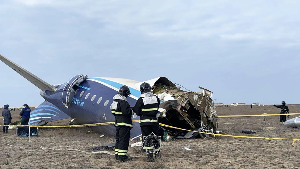 Kazakhstan's emergency situations ministry and emergency specialists work at the crash site of an Azerbaijan Airlines passenger jet near the western Kazakh city of Aktau, Dec.25 (AFP)