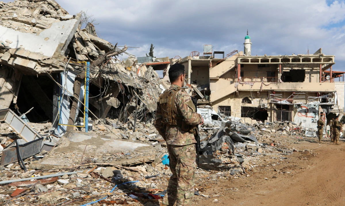 A Lebanese army member stands near rubble at a damaged site after the ceasefire between Israel and Hezbollah, in the Lebanese village of Khiam, December 23, 2024. (Reuters)