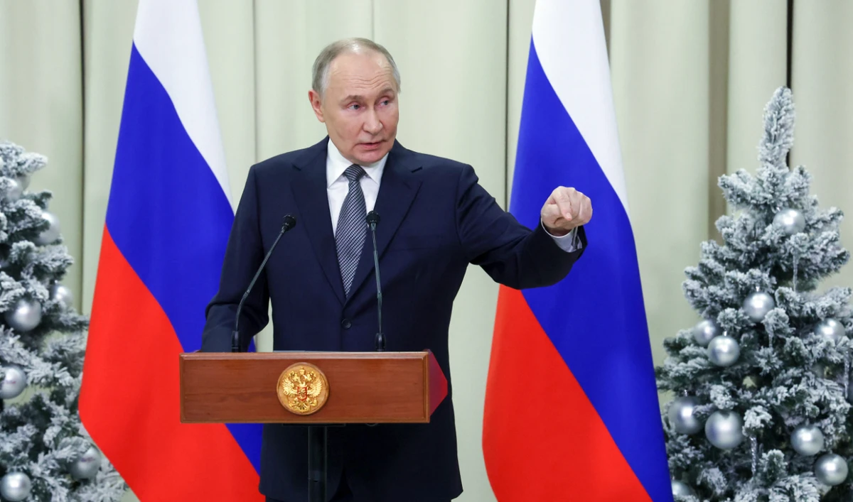 In this pool photograph distributed by the Russian state agency Sputnik, Russia's President Vladimir Putin meets with the media after a meeting of the Supreme Eurasian Economic Council at Igora ski resort in the Leningrad region on December 26, 2024. (AFP)