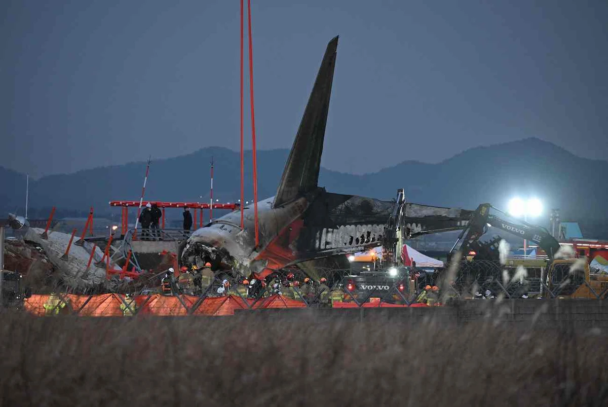 Firefighters work near the scene where a Jeju Air Boeing 737-800 series aircraft crashed and burst into flames at Muan International Airport in South Jeolla Province, on December 29, 2024. (AFP)