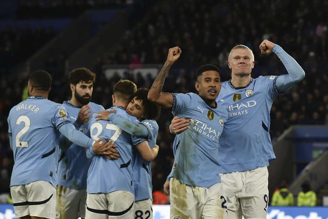 Manchester City’s Erling Haaland, right, celebrates with Savinho after scoring his side’s second goal during the English Premier League match between Leicester City and Manchester City at King Power stadium in Leicester. (AP)