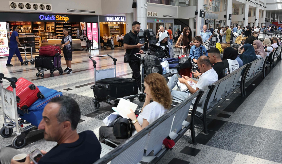 Passengers wait for their flights at the Beirut International Airport in Beirut on August 25, 2024. (AFP)
