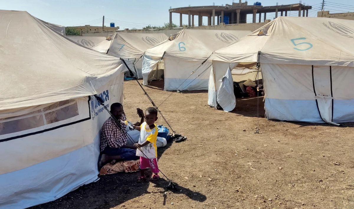 A child looks on as Sudanese people who fled escalating violence in the Al-Jazira state rest at a camp for the displaced in the eastern city of Gedaref on November 23, 2024. (AFP/File)