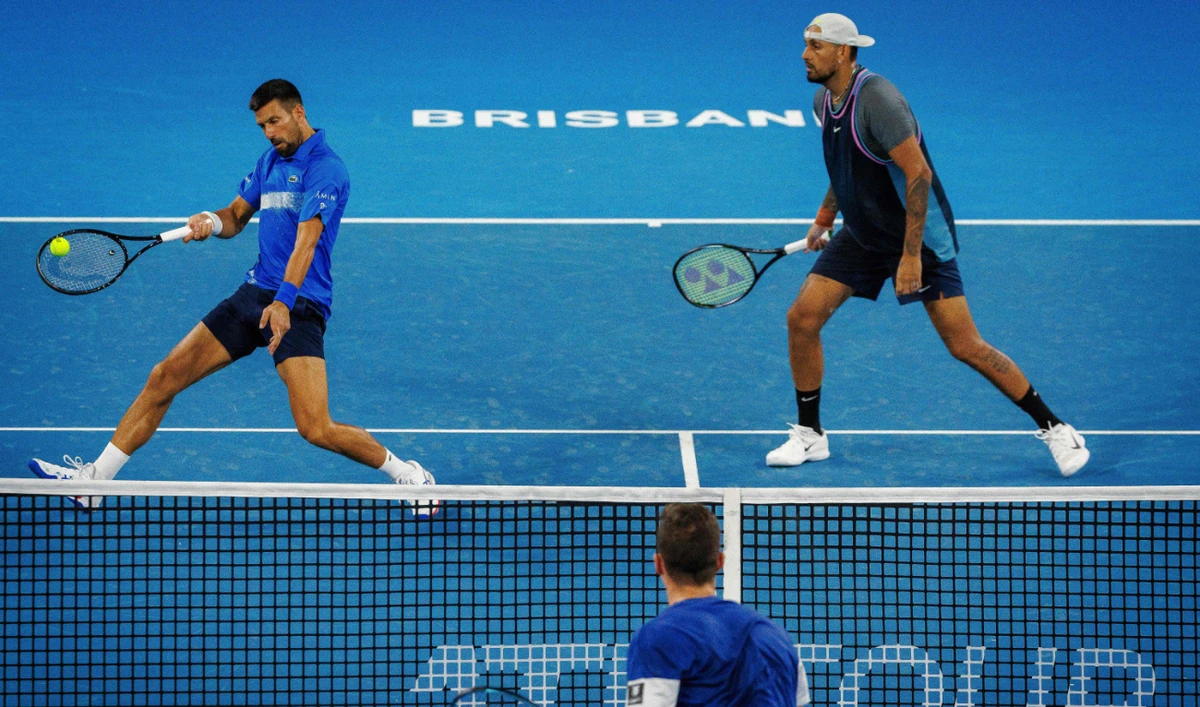 Australia’s Nick Kyrgios, right, and Serbia’s Novak Djokovic hit a return during their men’s doubles match against Australia’s Alexander Erler and Germany’s Andreas Mies at the Brisbane International tennis tournament on Monday. (AFP)