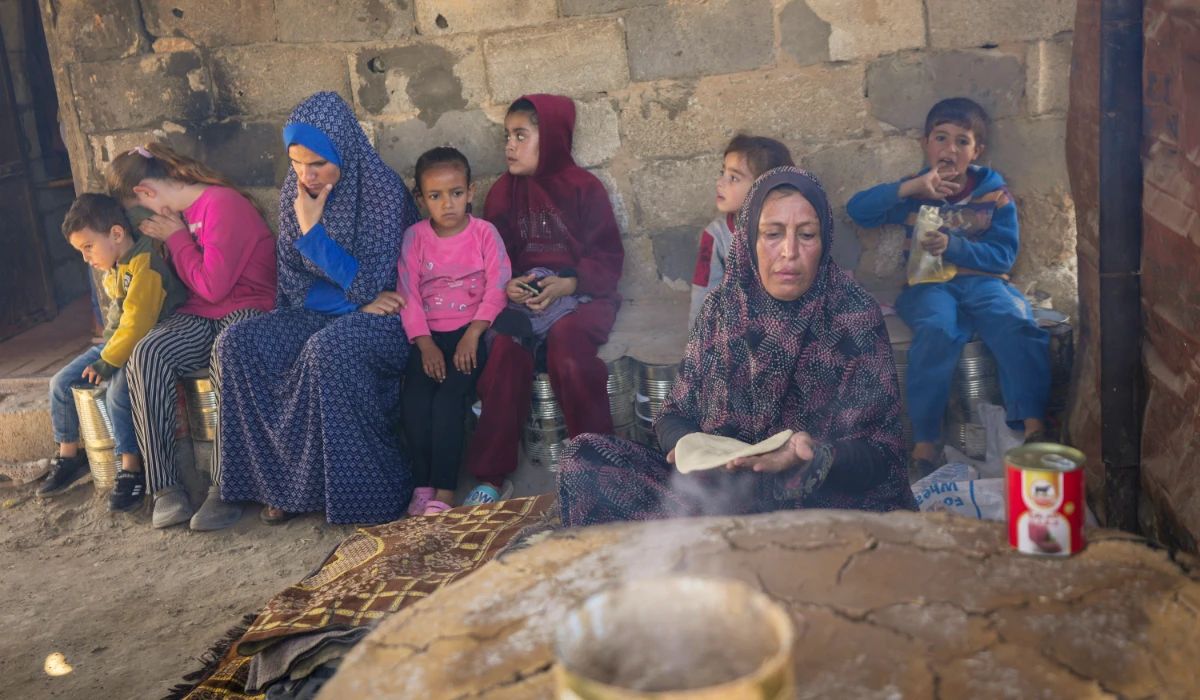 Amal Al-Jali, a 46-year-old mother of 14 displaced from Gaza City, prepares bread at a camp for displaced Palestinians in Deir al-Balah, Gaza Strip, on Nov. 7, 2024. (AP)