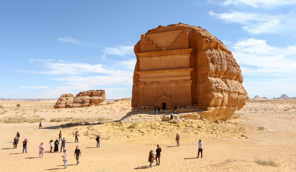 Visitors are seen in front of Qasr al-Farid tomb at the Madain Saleh antiquities site in Al-Ula, Saudi Arabia. (REUTERS)