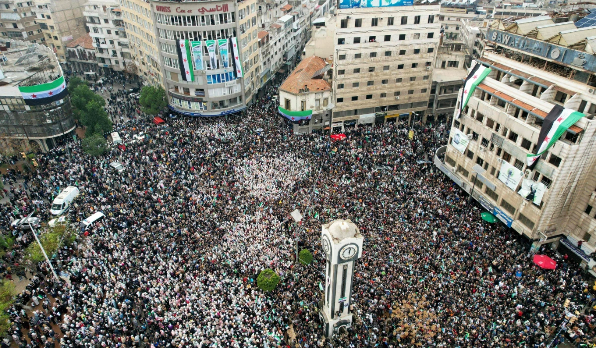 Syrians around the Clock Tower in Homs as they celebrate the fall of Bashar al-Assad's iron-fisted rule. (AFP)