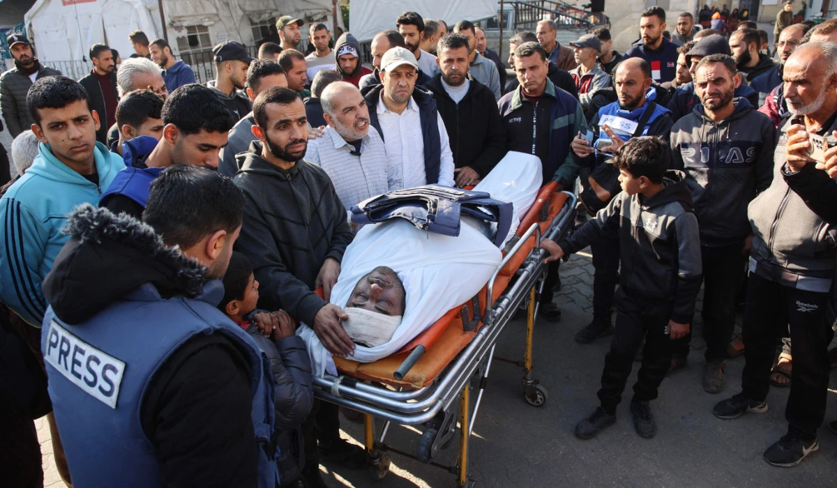 Mourners surround the body of Palestinian journalist Mamduh Qantiya who was killed in an Israeli strike in Gaza. (AFP)