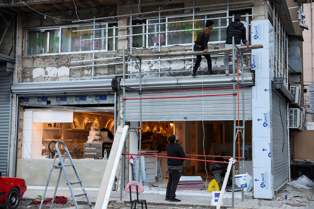 Above, people repair a shop in Beirut’s southern suburbs on Jan. 24, 2025. (Reuters)