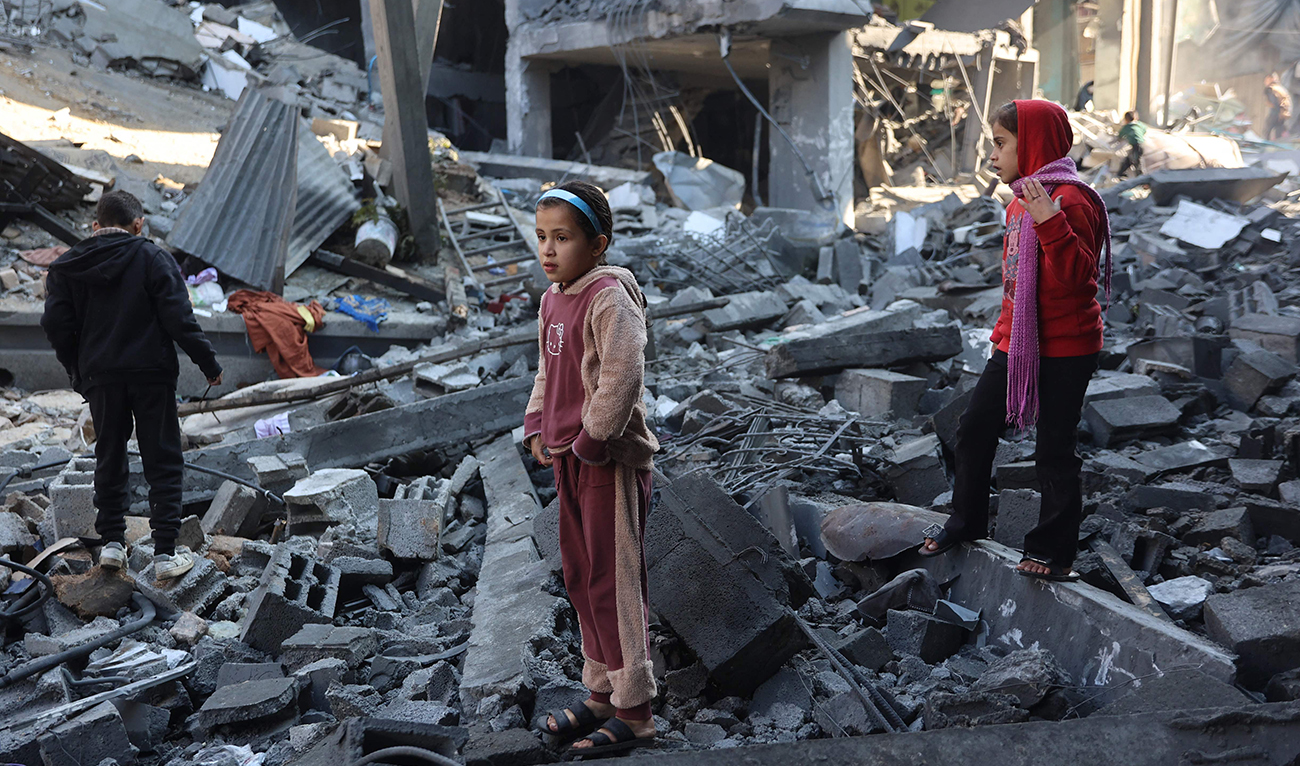Palestinian children inspect the damage at the site of an Israeli strike the previous night, in Jabalia, in the central Gaza Strip on January 1, 2025, as the war between Israel and Hamas continues. (AFP)