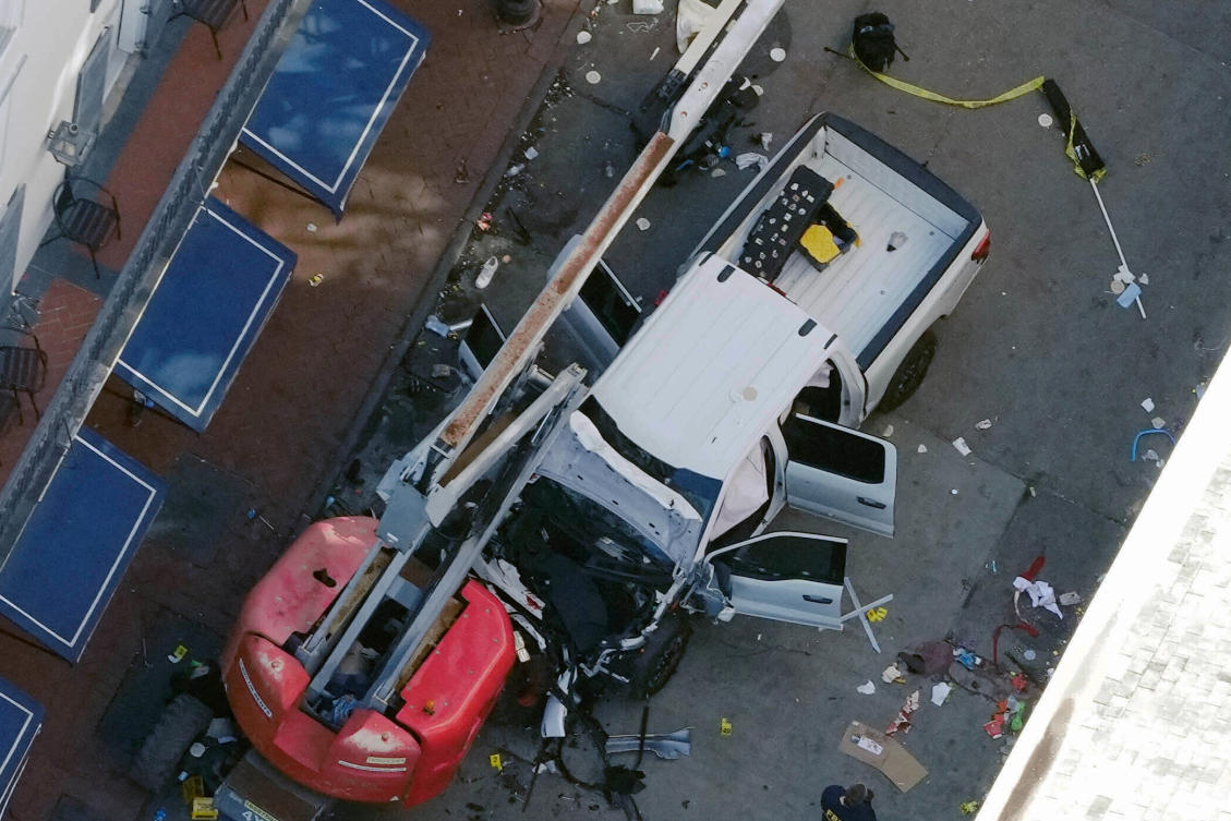 A black flag with white lettering lies on the ground rolled up behind a pickup truck that a man drove into a crowd on Bourbon Street in New Orleans, killing and injuring a number of people, early Wednesday morning, Jan. 1, 2025. (AP)