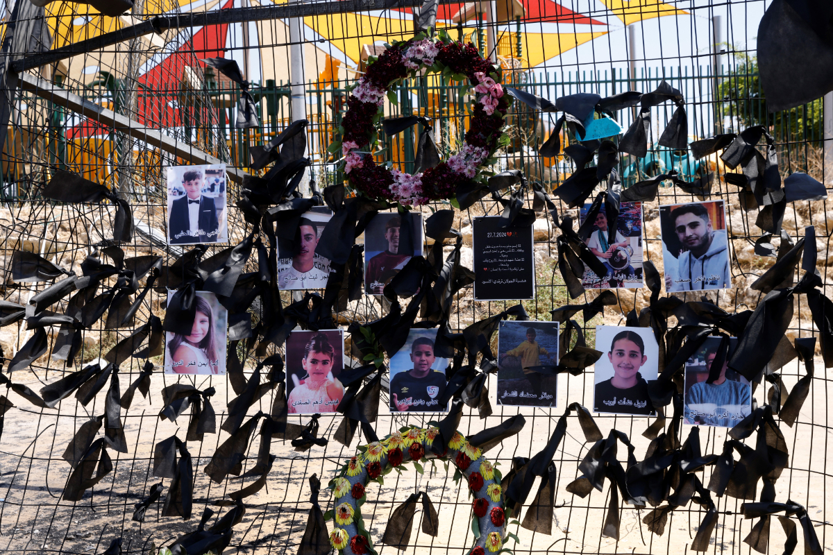 Portraits of the children and youngsters who were killed in a Hezbollah rocket attack on July 27, 2024, hang on the football stadium fence in the Druze village of Majdal Shams in the Israel-annexed Golan Heights. (AFP file photo)