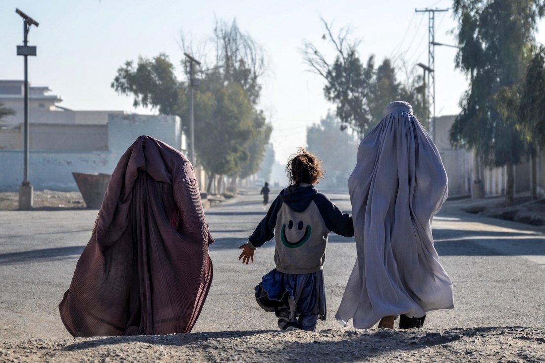 Afghan women and a girl walk along a street in Kandahar on Dec. 29, 2024. (AFP)