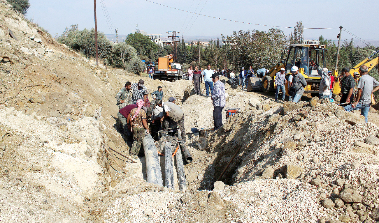 People inspect a damaged area in the aftermath of an Israeli strike in Masyaf in this Sept. 9, 2024 file photo. (Reuters)
