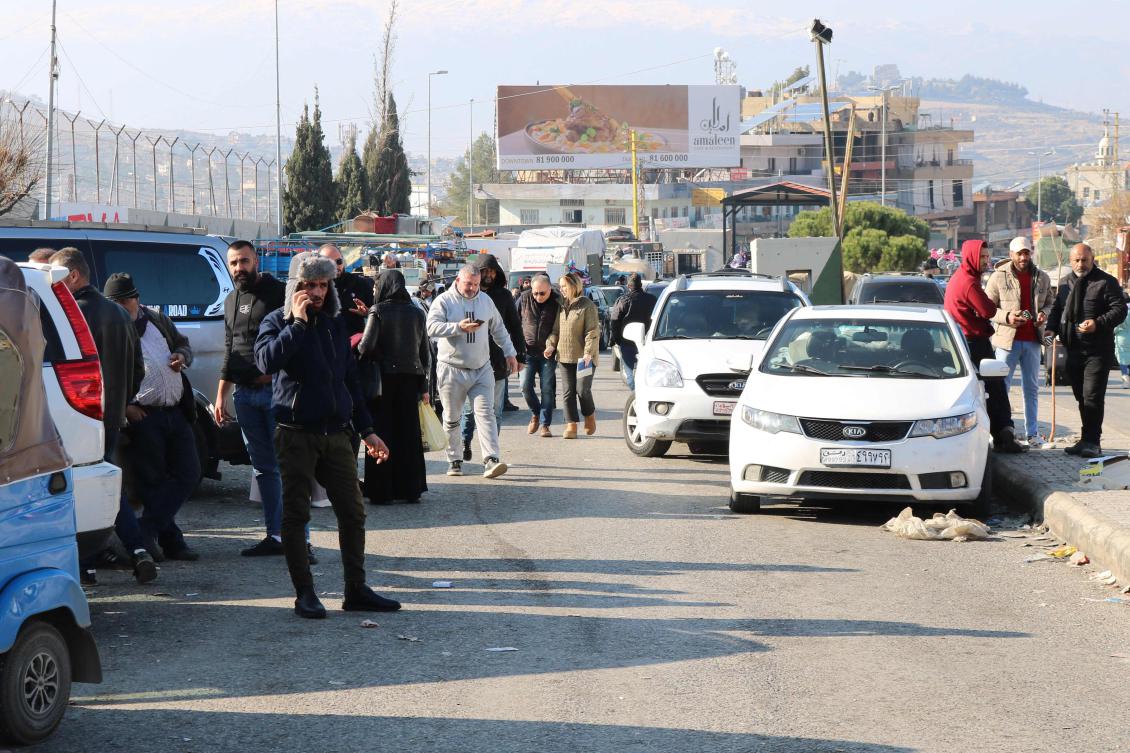 People wait at the entrance of the Al-Masnaa eastern Lebanese border crossing with Syria on Friday after Syria imposed new restrictions on the entry of Lebanese citizens. (AFP)