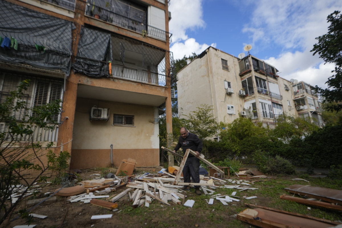 A man works next to damaged building near the site where a missile launched from Yemen landed Jaffa district, in Tel Aviv, Israel, on Dec. 31, 2024. (AP Photo)