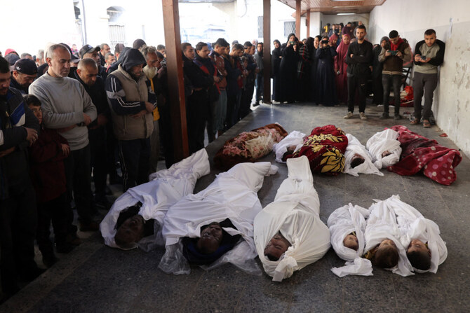 Palestinians recite a prayer over the bodies of members of the Ghoula family at the Al-Ahli Arab hospital, also known as the Baptist hospital, after their home was hit in an Israeli strike in the Shujaiya neighborhood of Gaza City on January 4, 2025. (AFP)