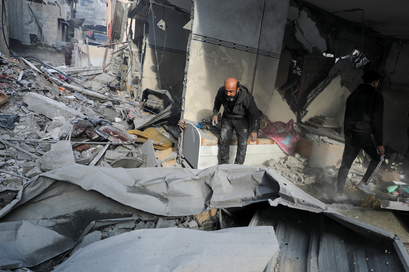 Palestinians inspect the site of an Israeli strike on a house in Gaza City, January 5, 2025. (Reuters)