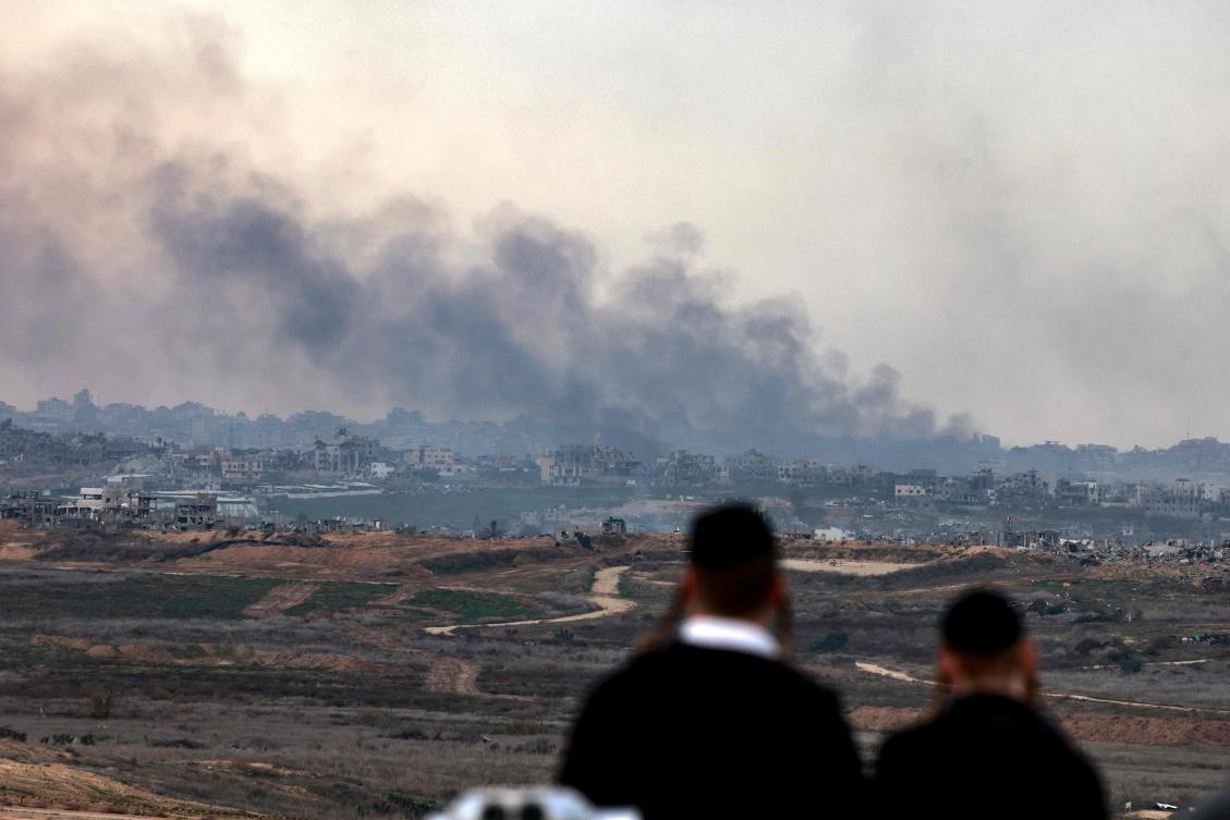 Israeli ultra-Orthodox Jewish men standing on a hill in the southern city of Sderot, watch as Israeli forces bombard the northern Gaza Strip on January 5, 2025, amid the ongoing war between Israel and Hamas militants. (AFP)
