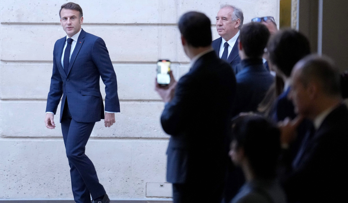 French President Emmanuel Macron (L) arrives to deliver his speech to French ambassadors posted around the world followed by France's Prime Minister Francois Bayrou, on January 6, 2025 at the Elysee Palace in Paris. (AFP)