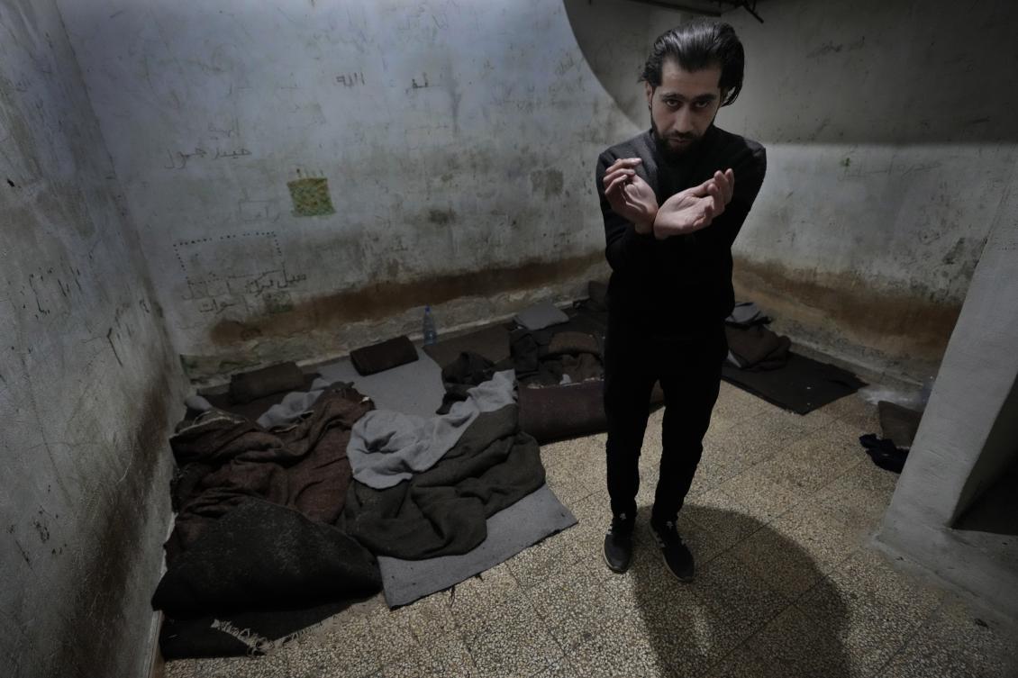 Abdullah Zahra demonstrates how he was tortured in a cell at Branch 215, a detention facility run by military intelligence during Bashar Assad's regime, in Damascus, Syria. (AP)