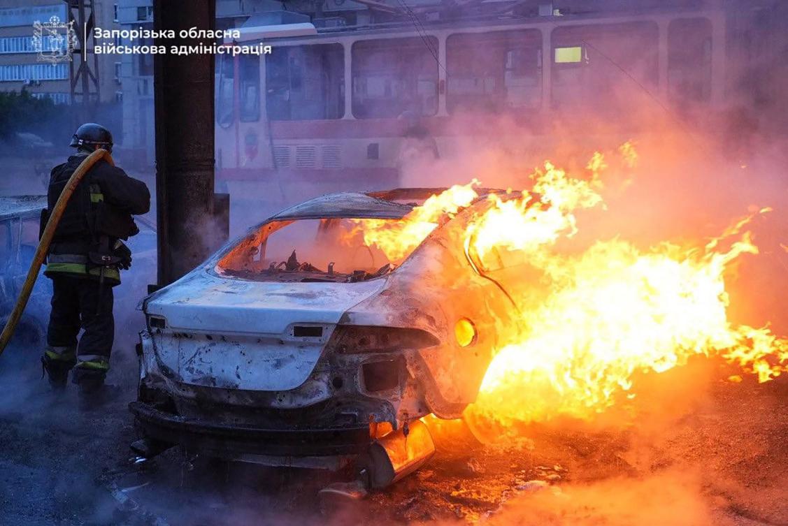 This handout photograph published on Jan. 8, 2025, on the official Telegram channel of the head of the Zaporizhzhia Regional Military Administration Ivan Fedorov, shows a firefighter extinguishing car in flames at the site of a Russian strike in Zaporizhzhia. (AFP)