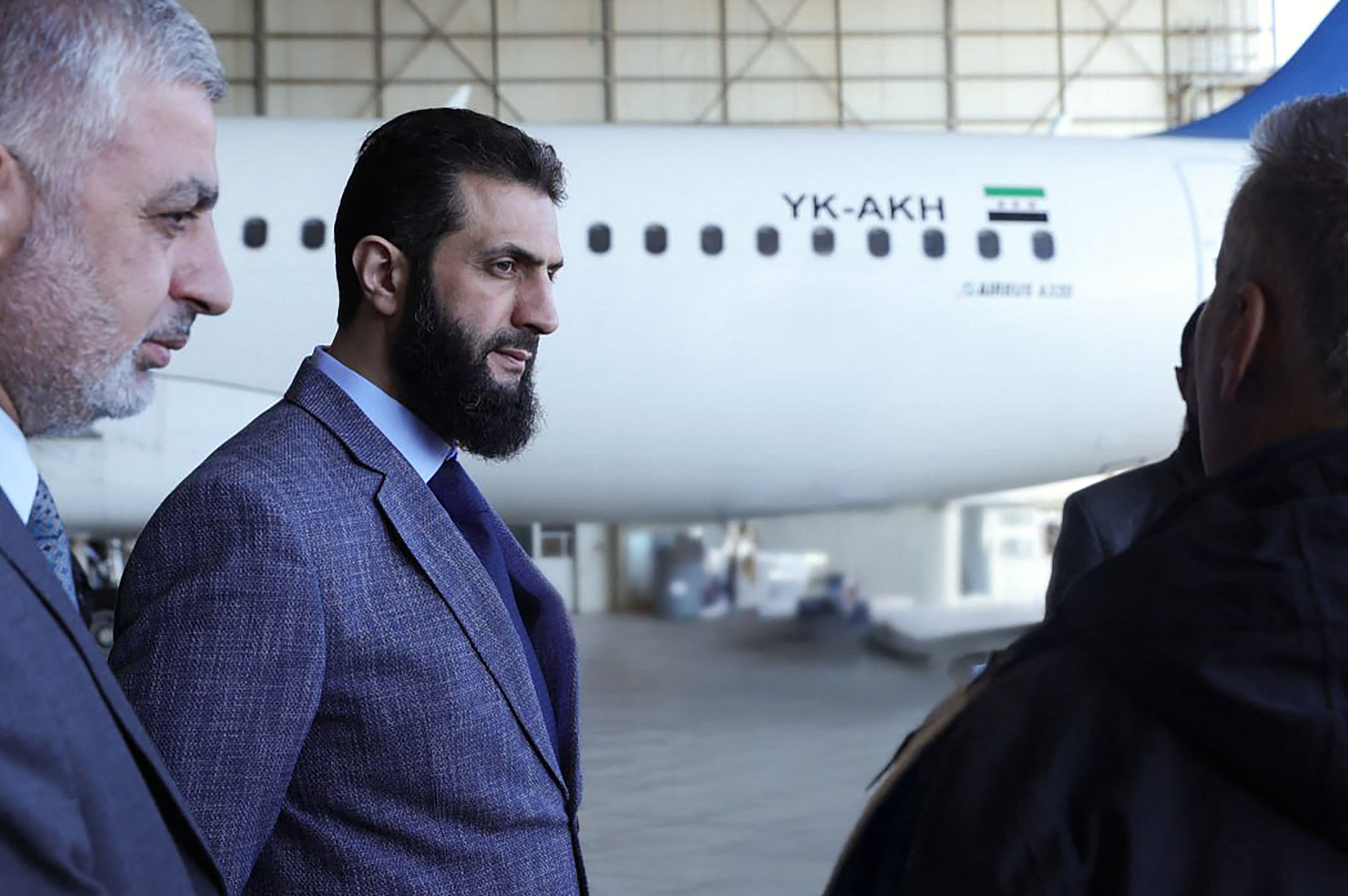 Syria's de facto leader Ahmed al-Sharaa talking to officials during a visit to Damascus International Airport, Jan. 7 (Photo by SANA / AFP)