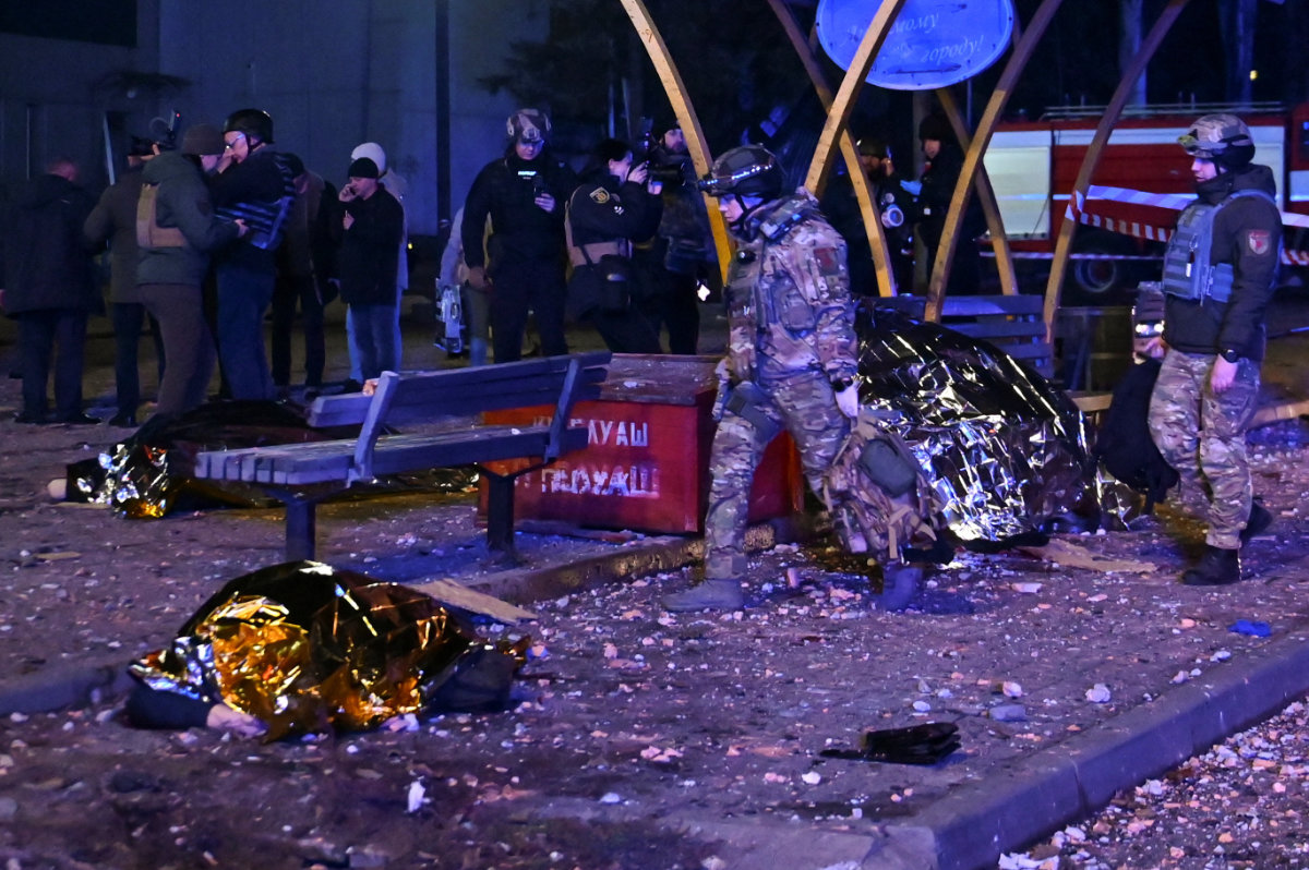 A police officer inspects the body of a resident killed at a stop of public transport during Russian air and missile strikes in Zaporizhzhia, Ukraine, on Jan. 8, 2025. (REUTERS)